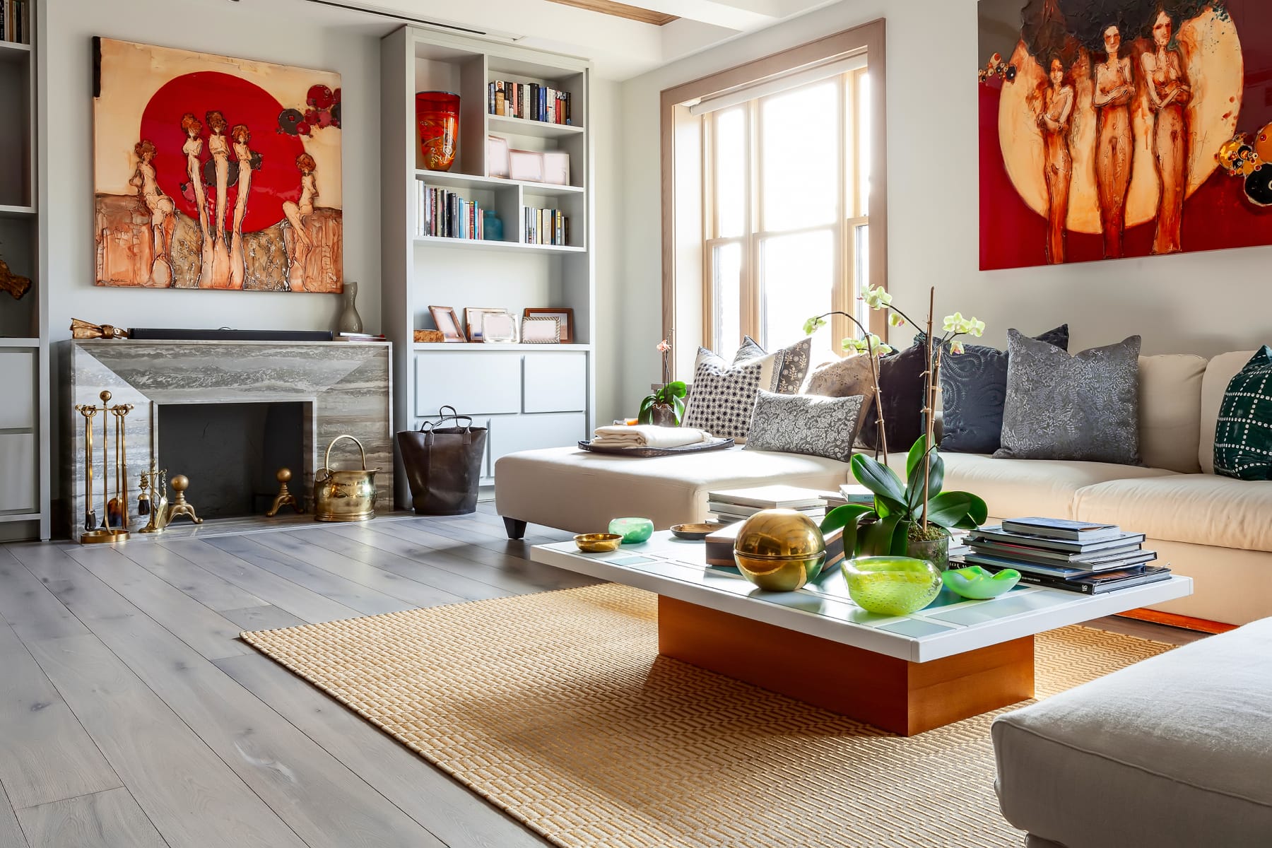 Living room with stone fireplace surround and cabinetry