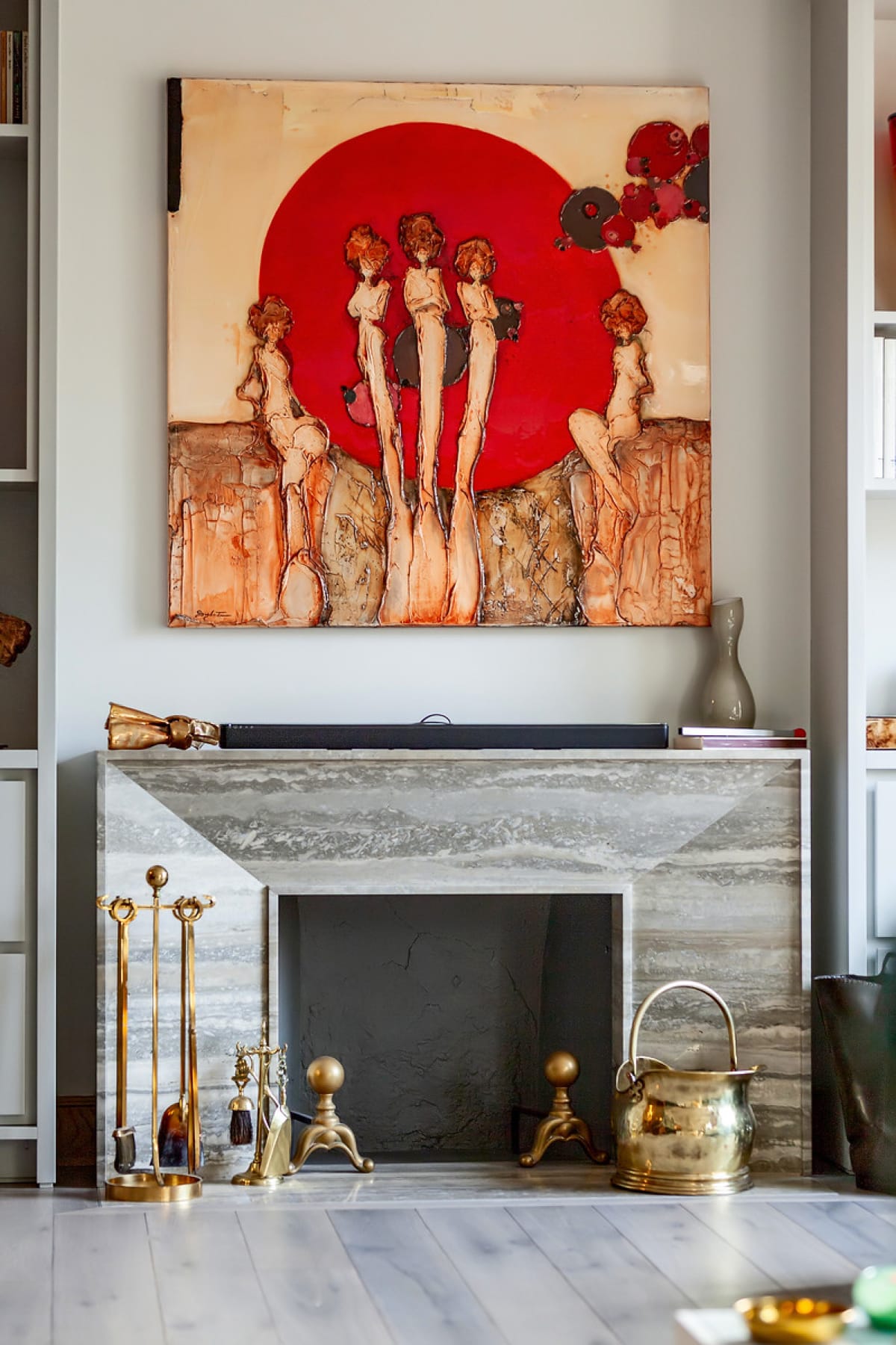 Living room with stone fireplace surround and cabinetry